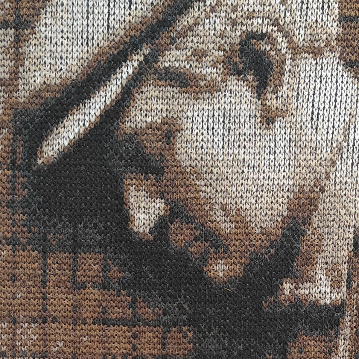 Detailed texture of fine knit design, celebrating luxury craft and exclusive textile art.