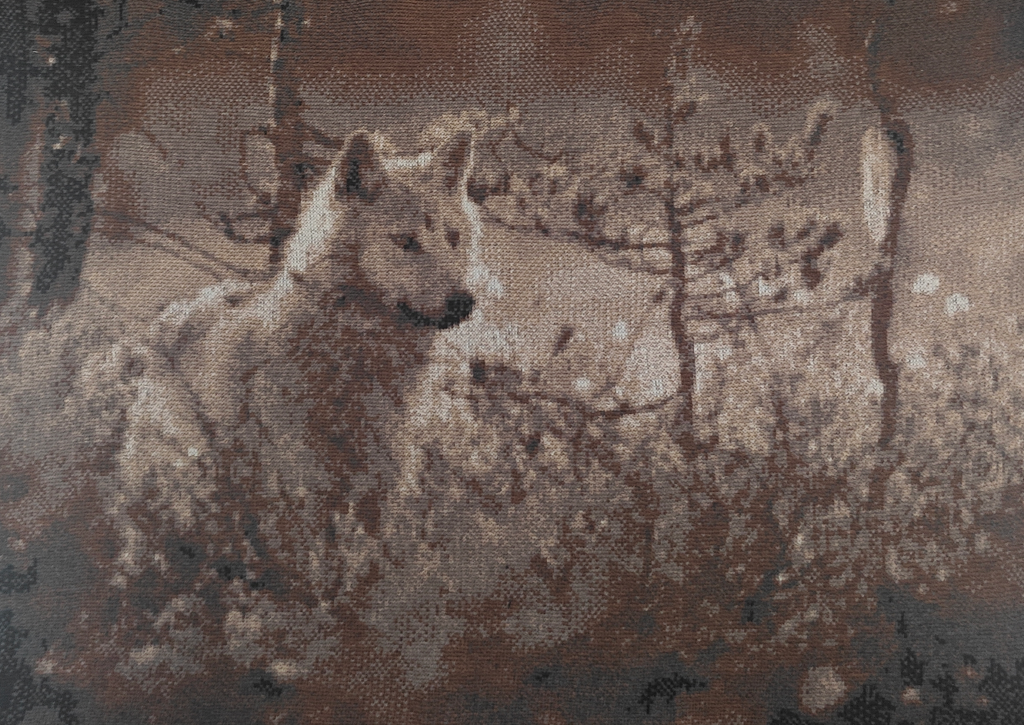 Close-up of Wolf acoustic art textile showing detailed merino wool stitches.