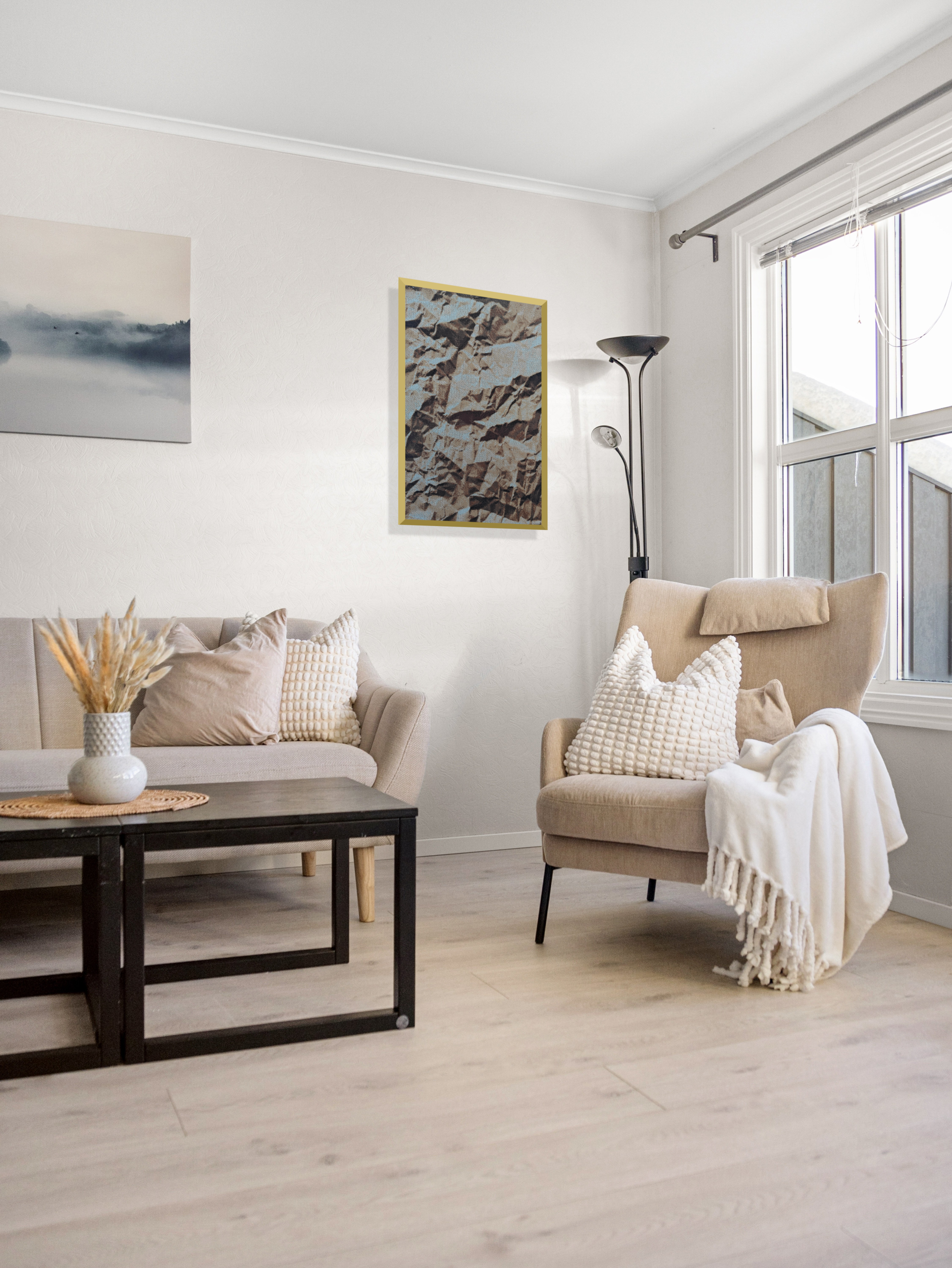 Modern Nordic living room interior featuring an acoustic textile art piece titled Crumpled by ArtKnitting on a white wall above a beige armchair.